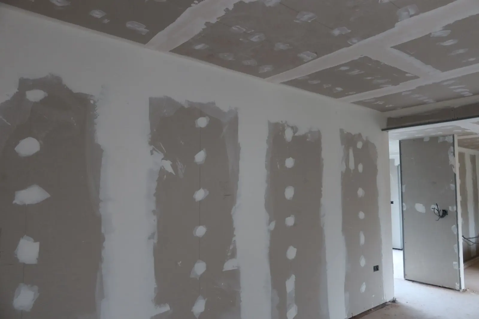 Newly installed plasterboard with jointing compound applied during an internal wall insulation and plastering project by Global Energy Insulation