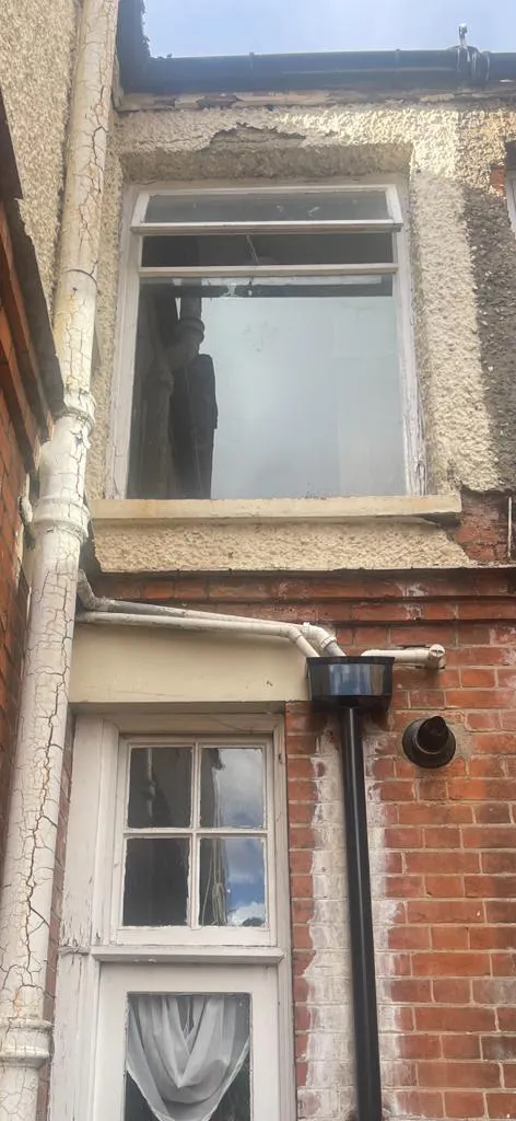 Exterior building maintenance showing damaged render and peeling paint on pipes, ready for professional painting services in Felixstowe.