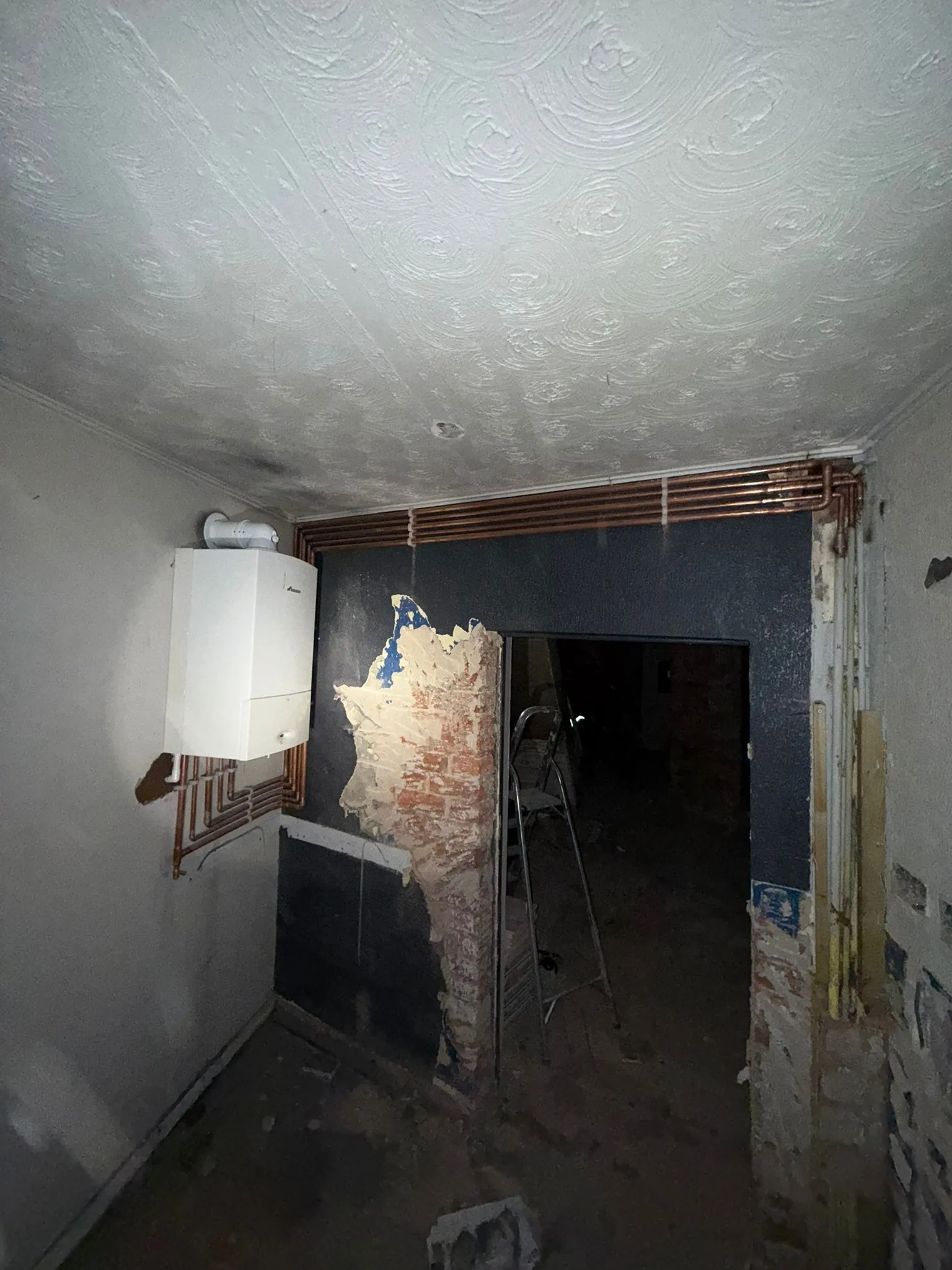 Professional boiler and central heating installation showing new copper pipework in a Warrington home.