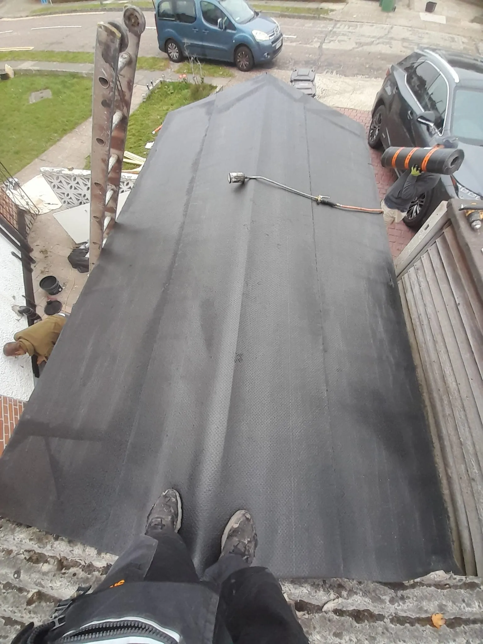 Professional flat roof installation being carried out by roofers in Cornwall.