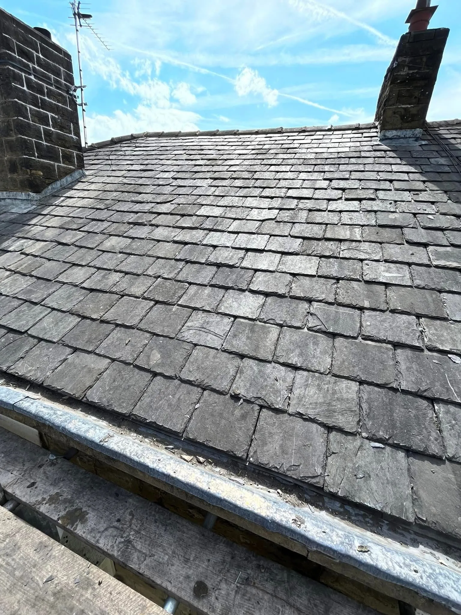 Expert slate and tile roofing installation in Blackburn by Lancashire Roofing Specialist, showing high-quality pitched roofing and chimney leadwork.