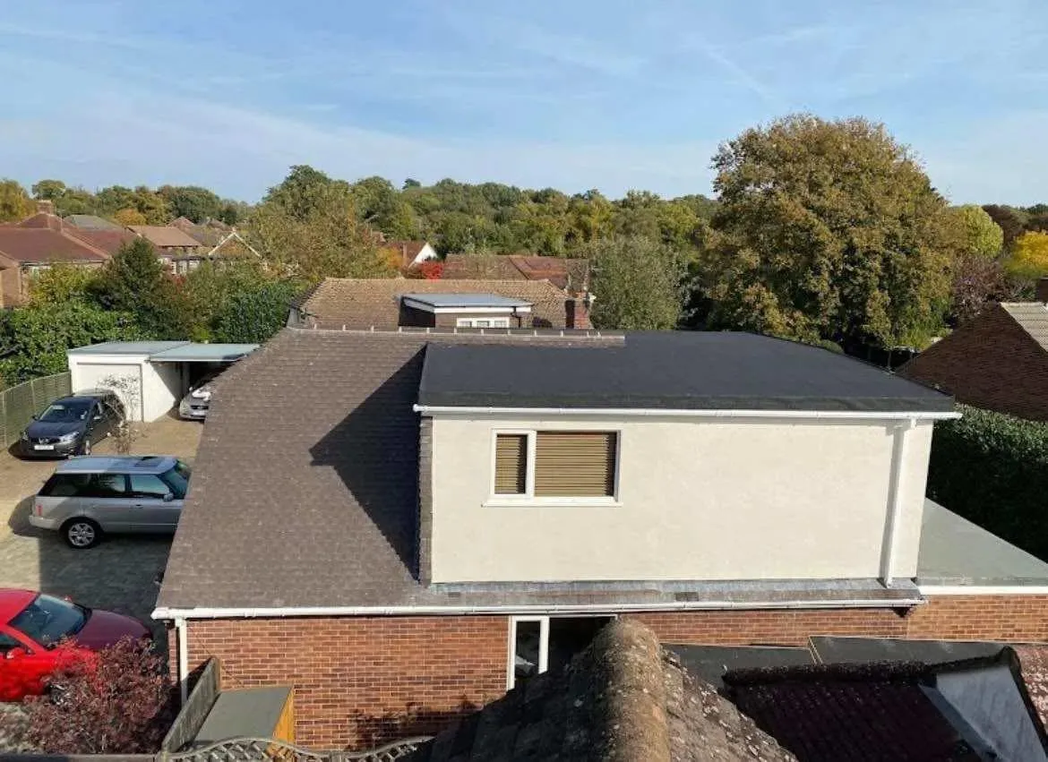 Aerial view showcasing a modern flat roof extension and a traditional pitched tiled roof on a residential property.