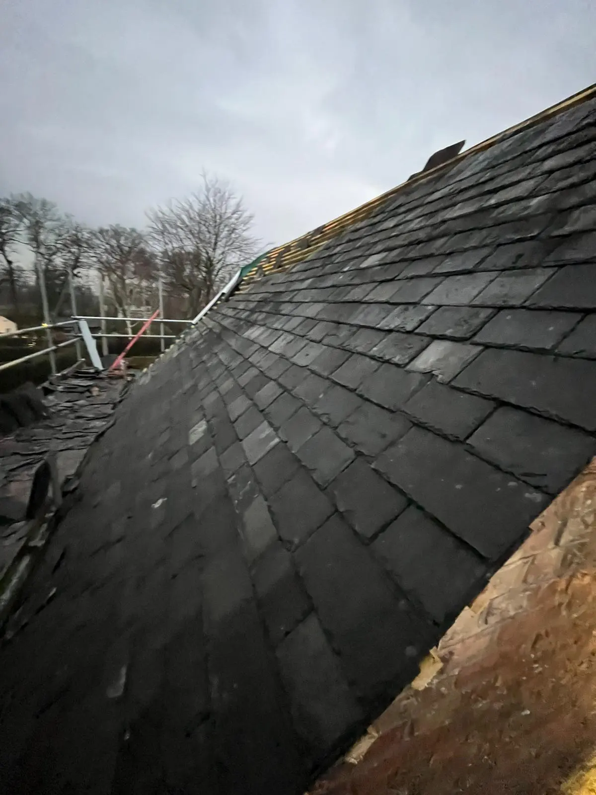 Close-up of a new slate roof installation in progress