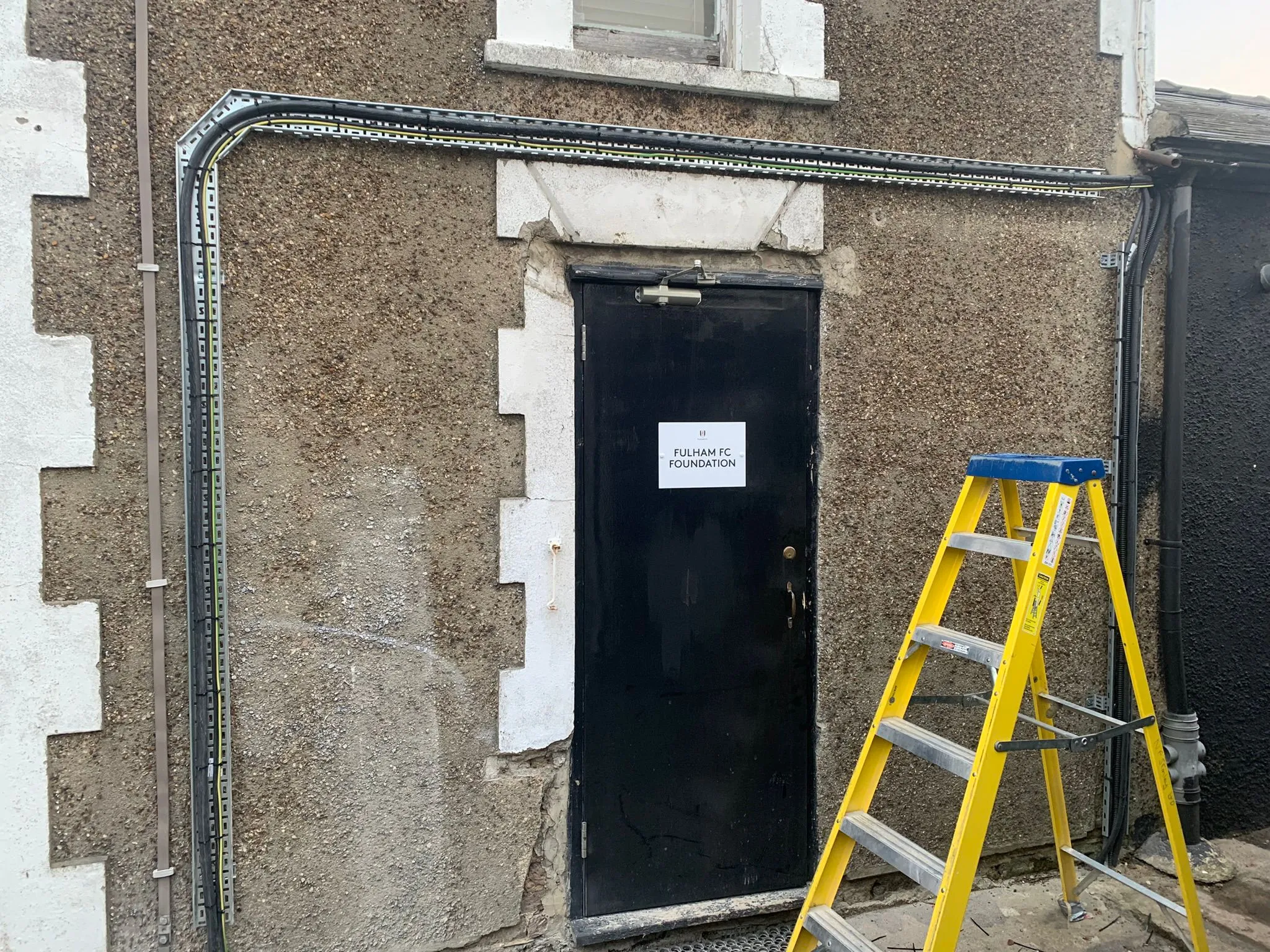 Commercial electrical cable containment and external wiring installed on a building exterior by Sussex Brown Sparks