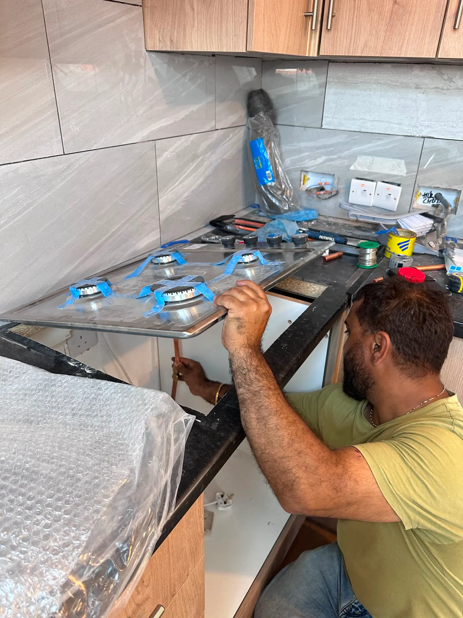 Gas Safe engineer carrying out a professional gas hob installation in a kitchen