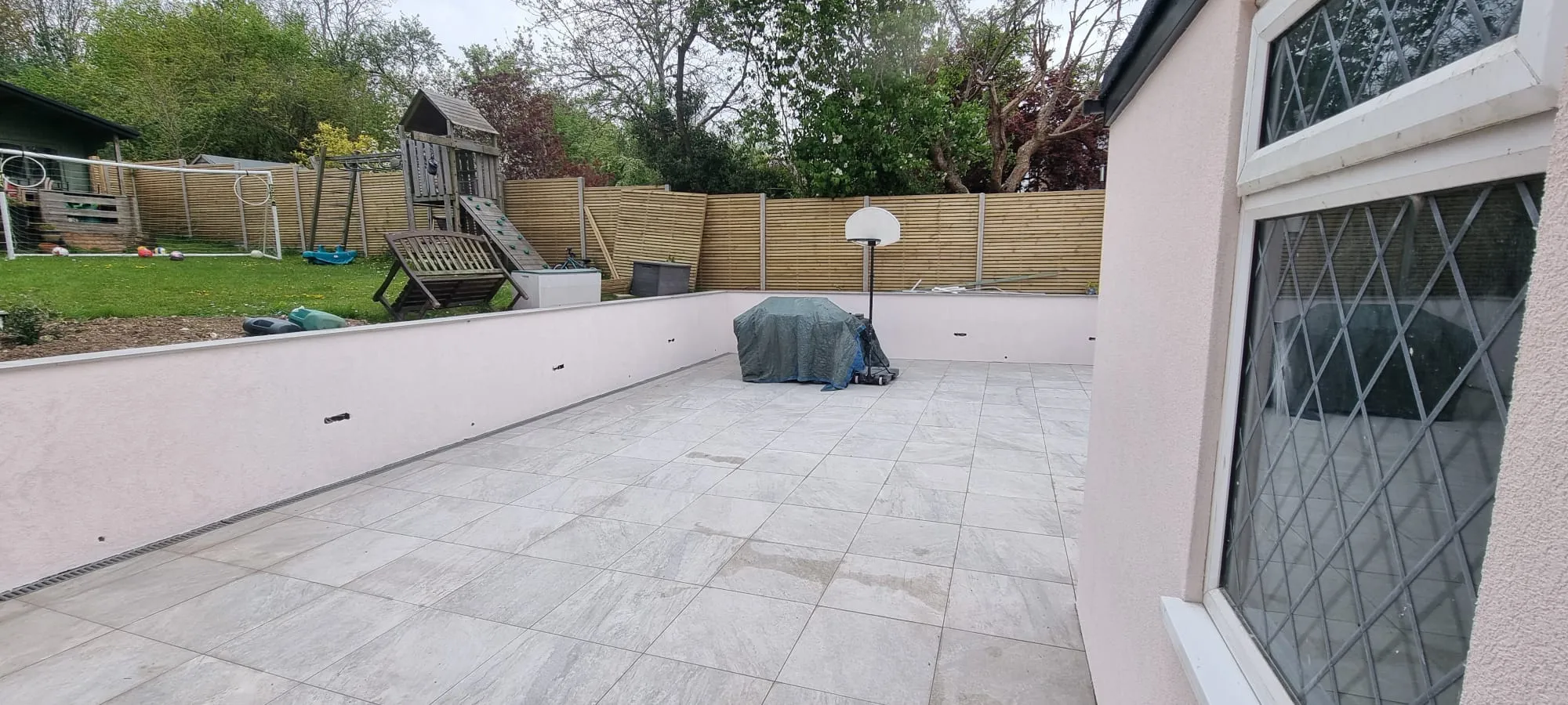 Freshly rendered garden walls and house exterior on a modern patio in Portslade.