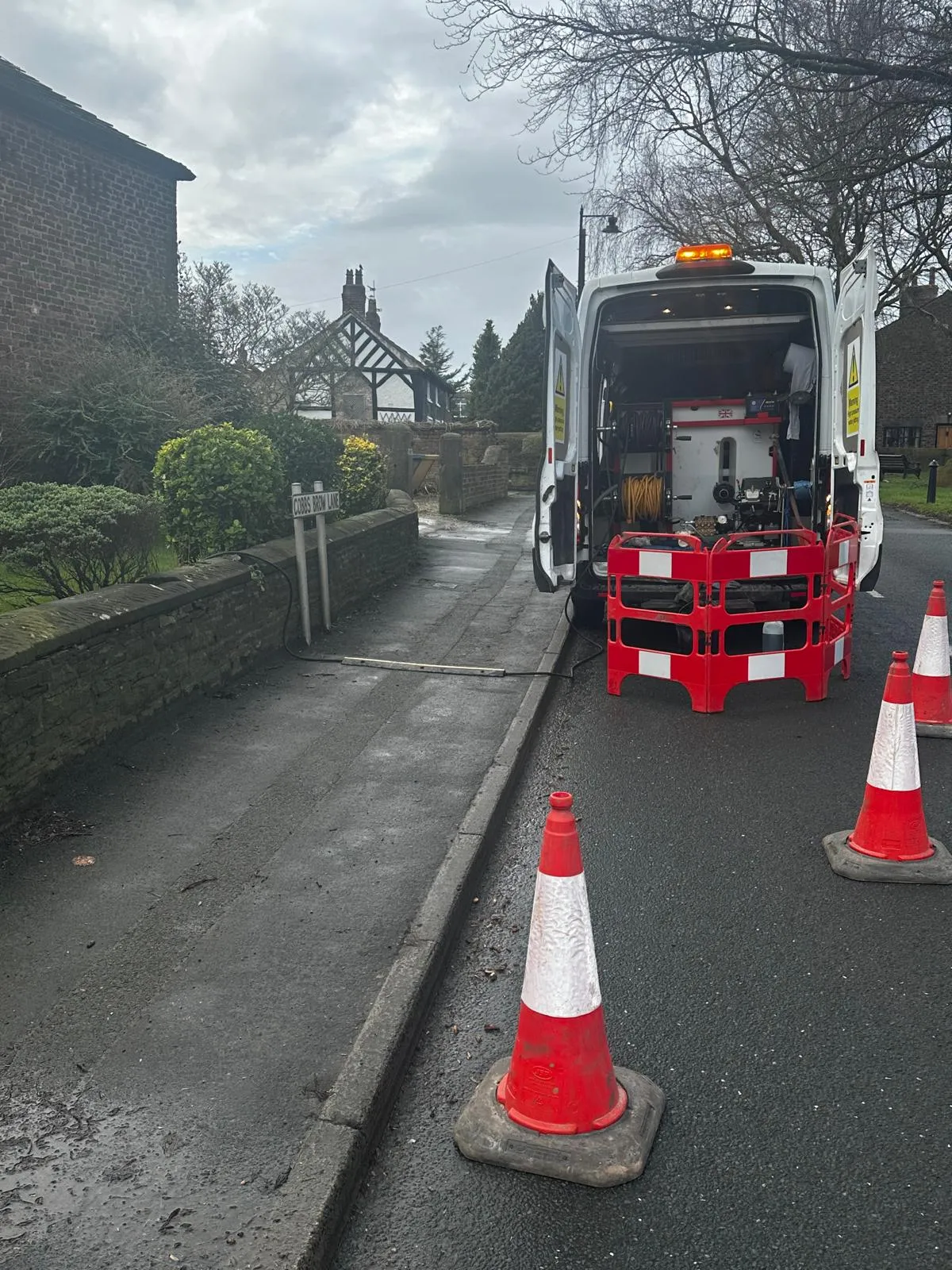 Drain Magic van with high-pressure jetting equipment and safety cones on Cobbs Brow Lane, ready for drain unblocking.