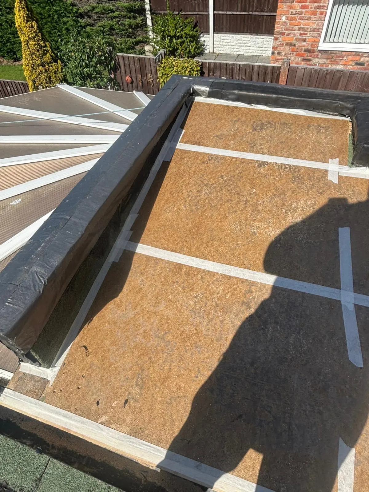 OSB timber decking boards with taped seams during the preparation stage of a flat roof installation