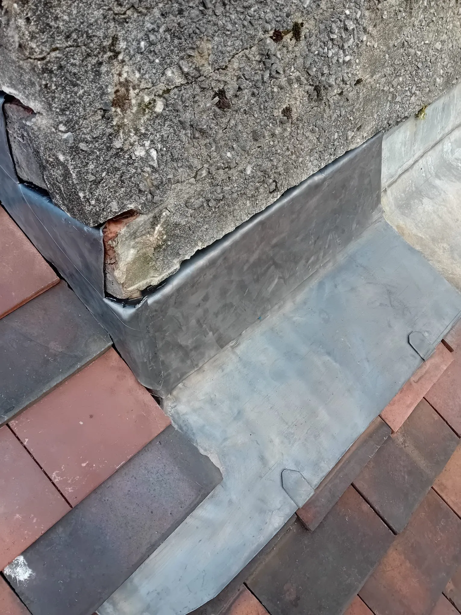 Professional lead flashing installation on a tiled roof in Gloucestershire by PRS Roofing.