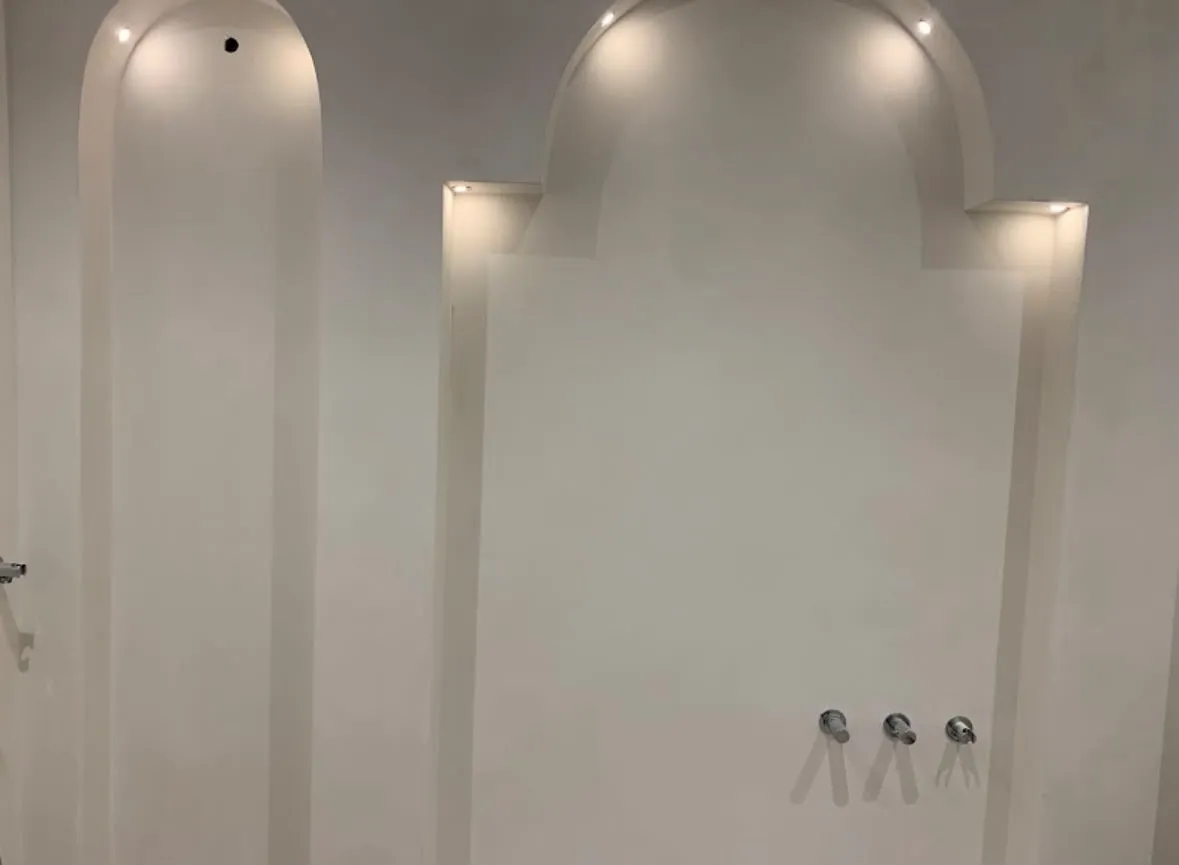 Architectural feature lighting installed in curved wall alcoves and niches