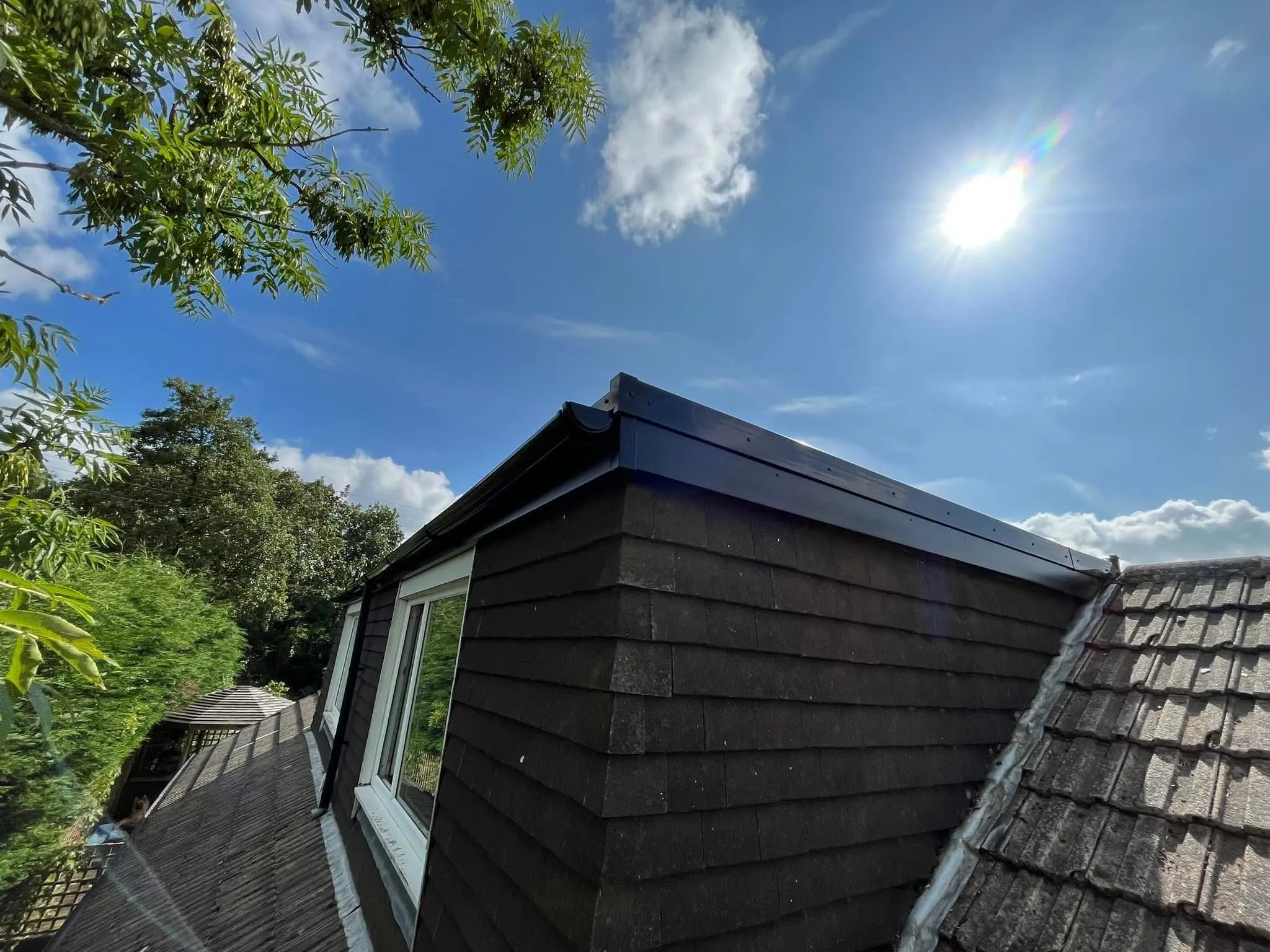 Professional uPVC fascia and guttering installation on a flat roof dormer in Blackburn by Lancashire Roofing Specialist.