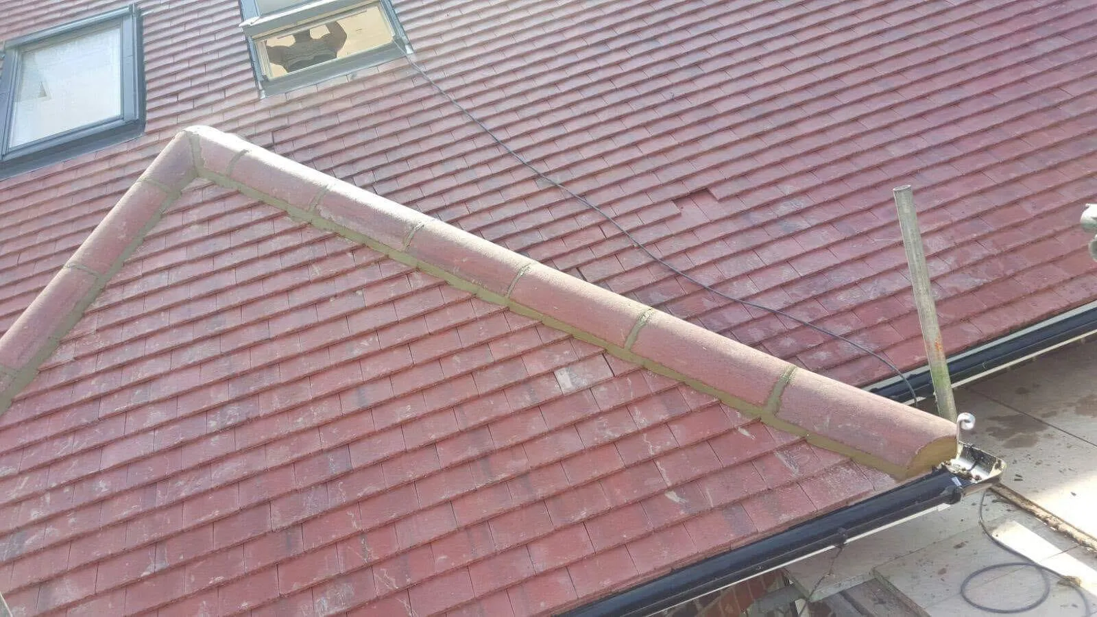 Professional tile roofing and ridge tile pointing by Firmus Roofing & Building on a residential property.