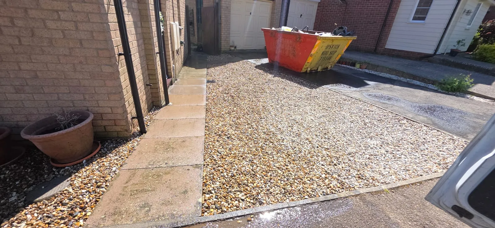 Clean shingle driveway and paved side path at a house in Suffolk
