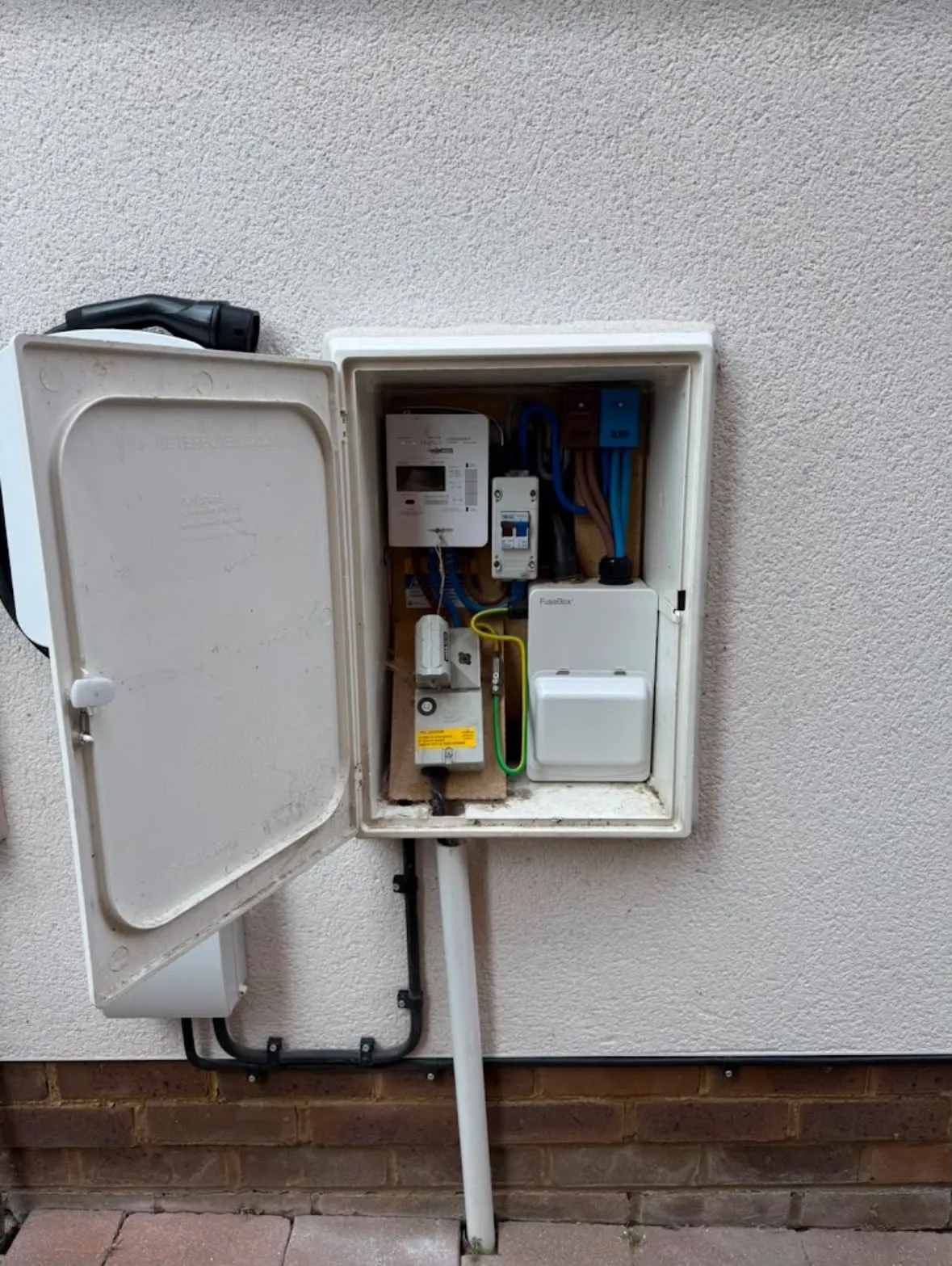 External meter box with dedicated EV charger consumer unit and charging cable holster