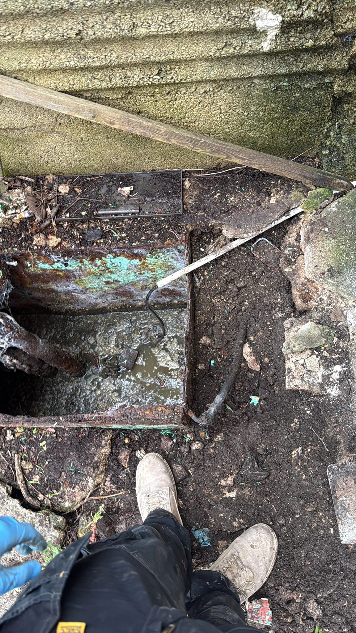 A professional engineer inspecting a blocked external drain at a residential property in Bournemouth.
