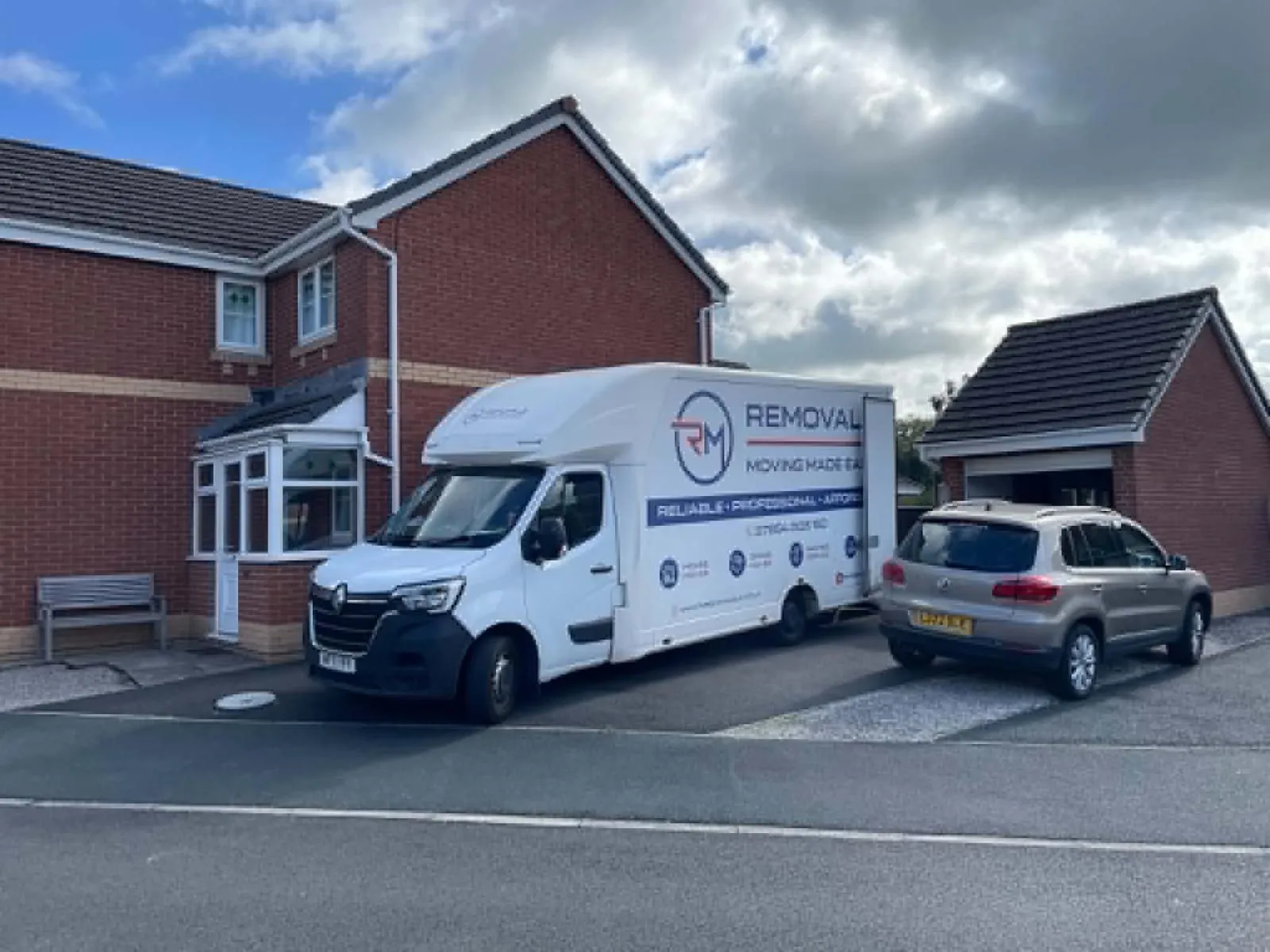 RM Removals van parked outside a residential home during a house move