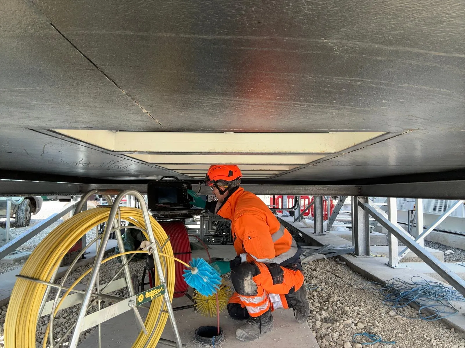 A professional drainage engineer from Drain Magic performing high-pressure drain jetting to clear a blockage.