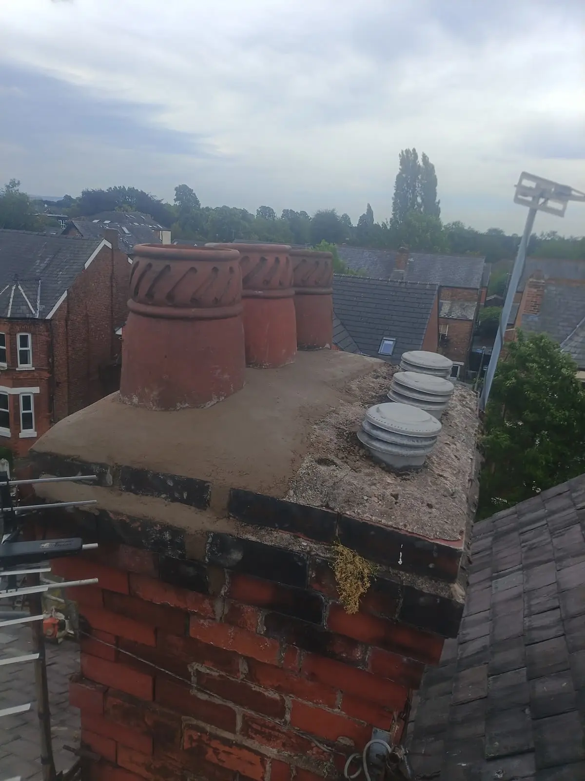 Expert chimney repointing and repair work on a slate roof in Lancashire