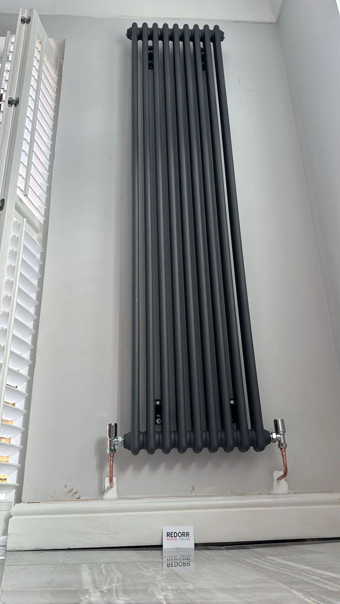 Modern anthracite designer radiator installation in a Warrington home by Redorr Heating & Cooling Services Ltd.