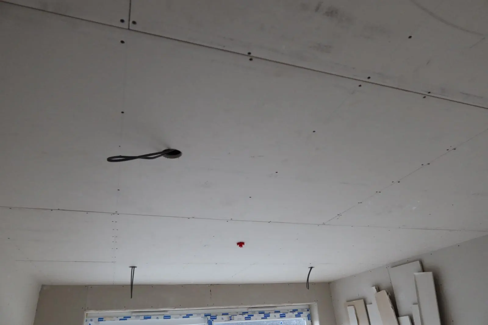 Expert dry lining installation showing a newly boarded ceiling ready for plastering