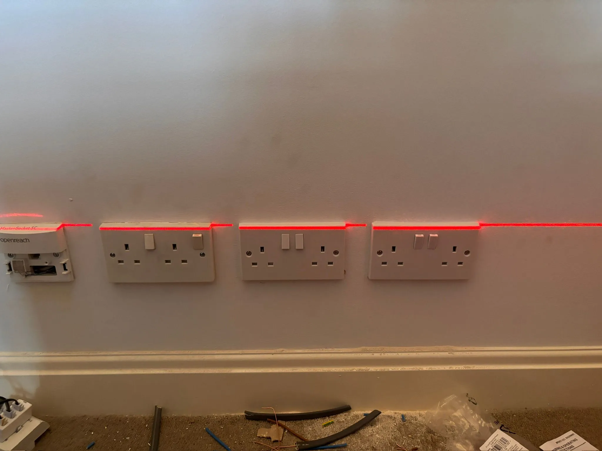 Precision laser alignment of UK electrical sockets during installation by Sussex Brown Sparks