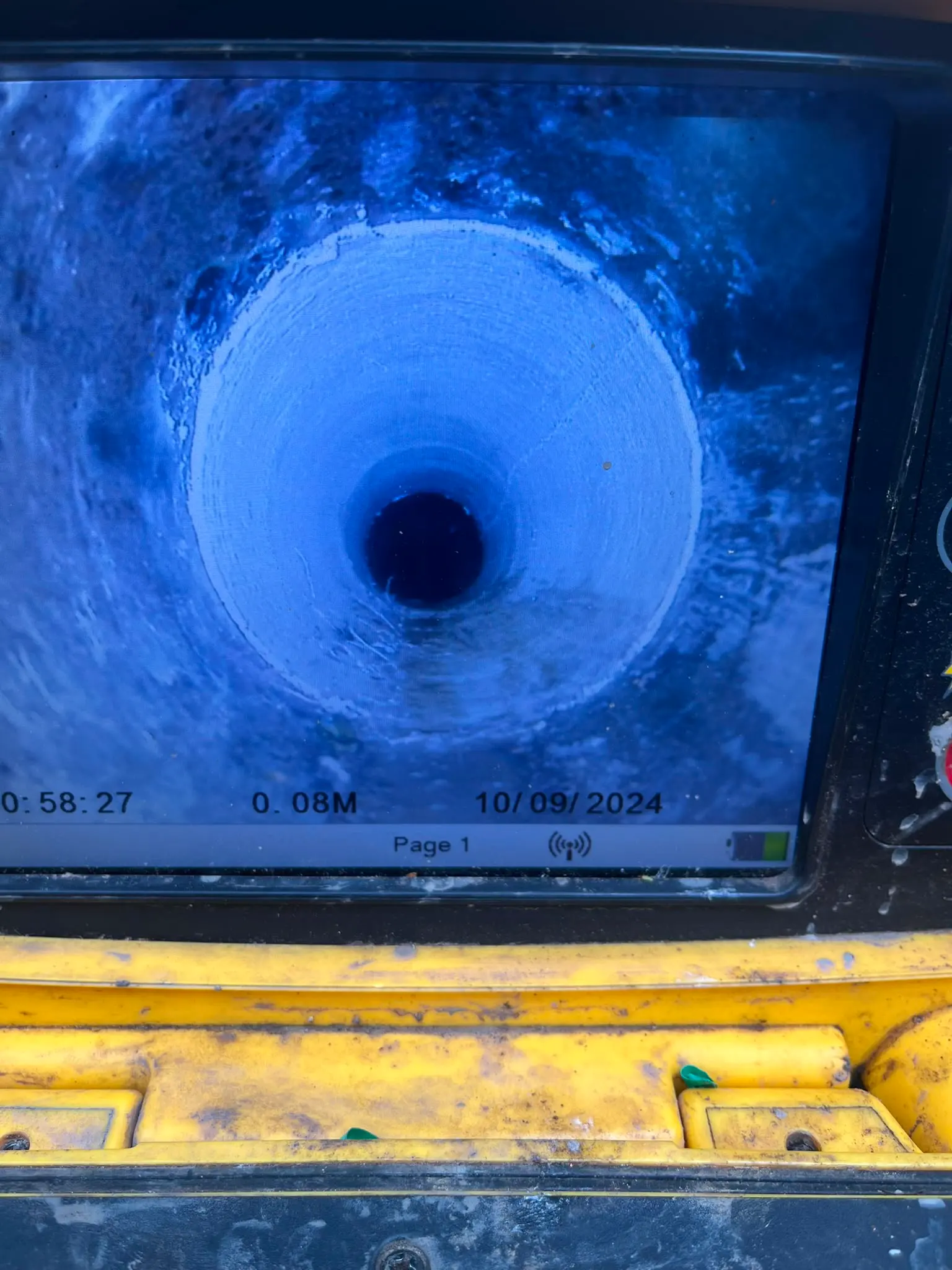CCTV drain survey monitor showing the inside of a clear pipe during an inspection by CB Drainage in the Central Belt