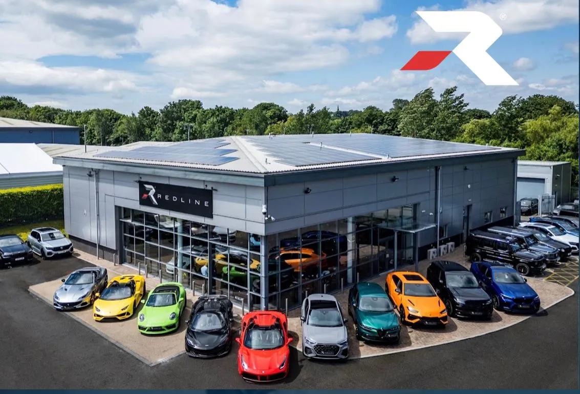 A luxury car dealership showroom with high-end sports cars parked outside in Harrogate