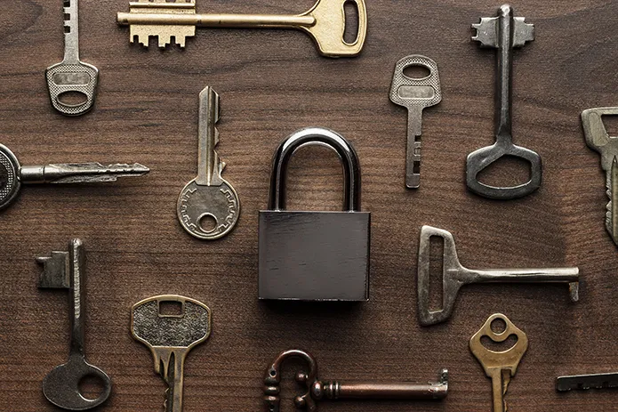 A picture of various keys and a padlock.