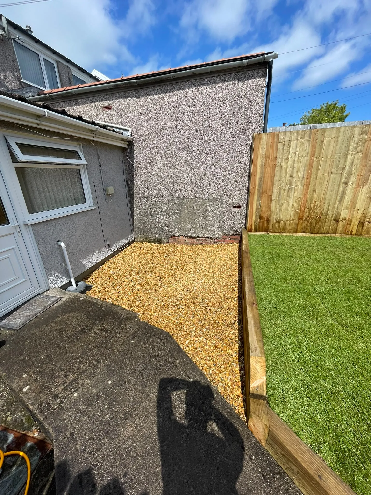 New featheredge timber boundary fencing and timber sleeper borders in a landscaped residential garden