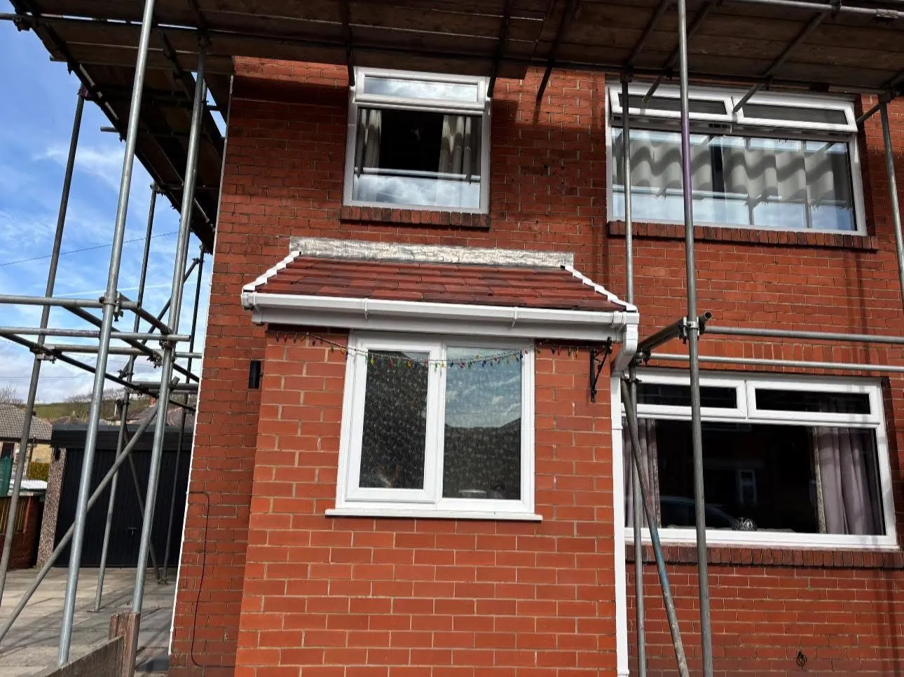 New pitched tile roof and uPVC roofline installation on a brick house extension by Lancashire Roofing Specialist.