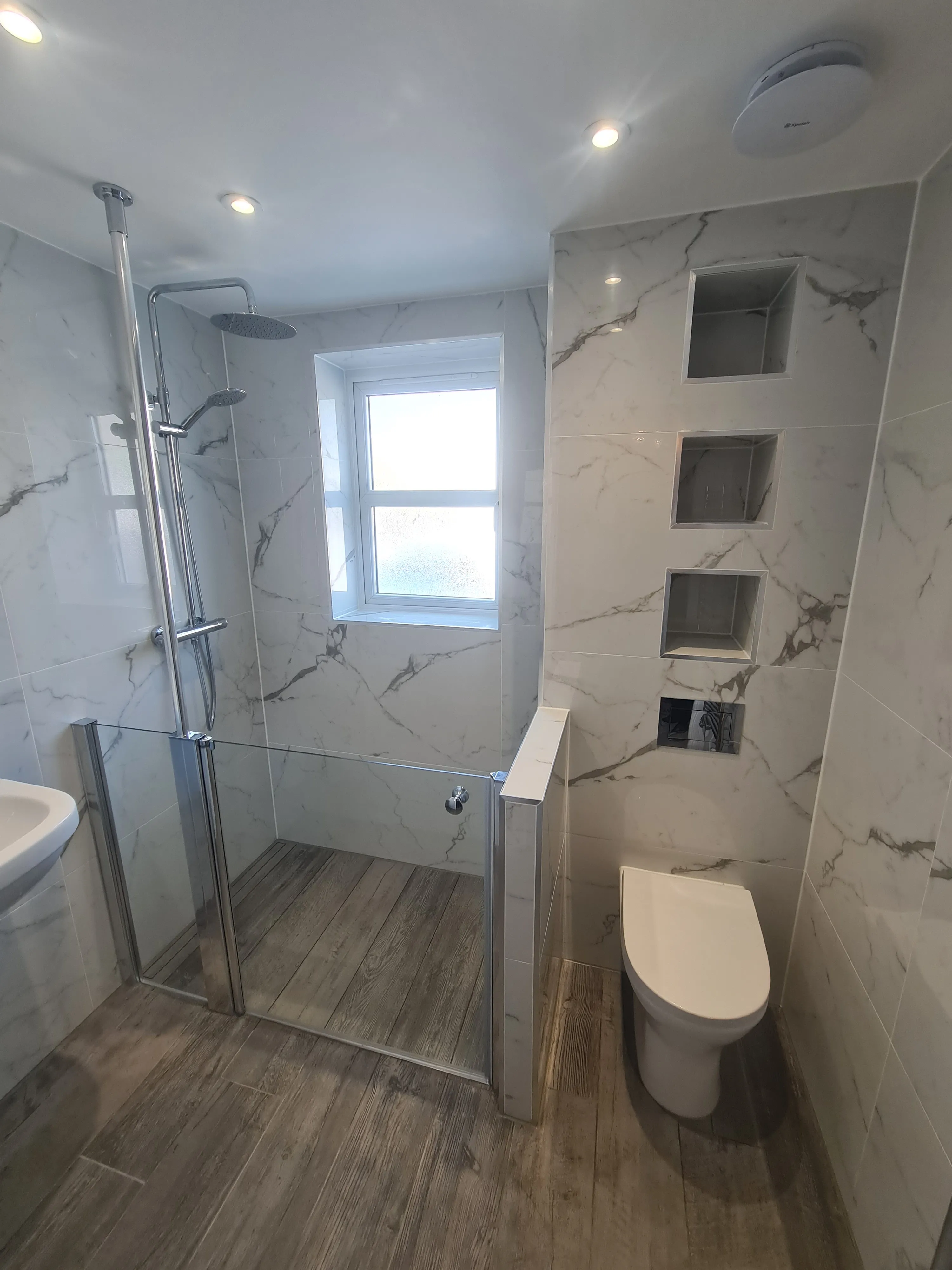Luxury walk-in shower and turnkey bathroom renovation in Plymouth featuring high-end tiling and modern fixtures.