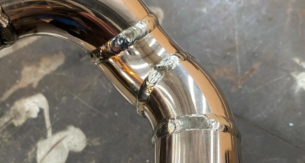 High-quality TIG welding on a polished stainless steel pipe by RA Steelworks Services LTD.