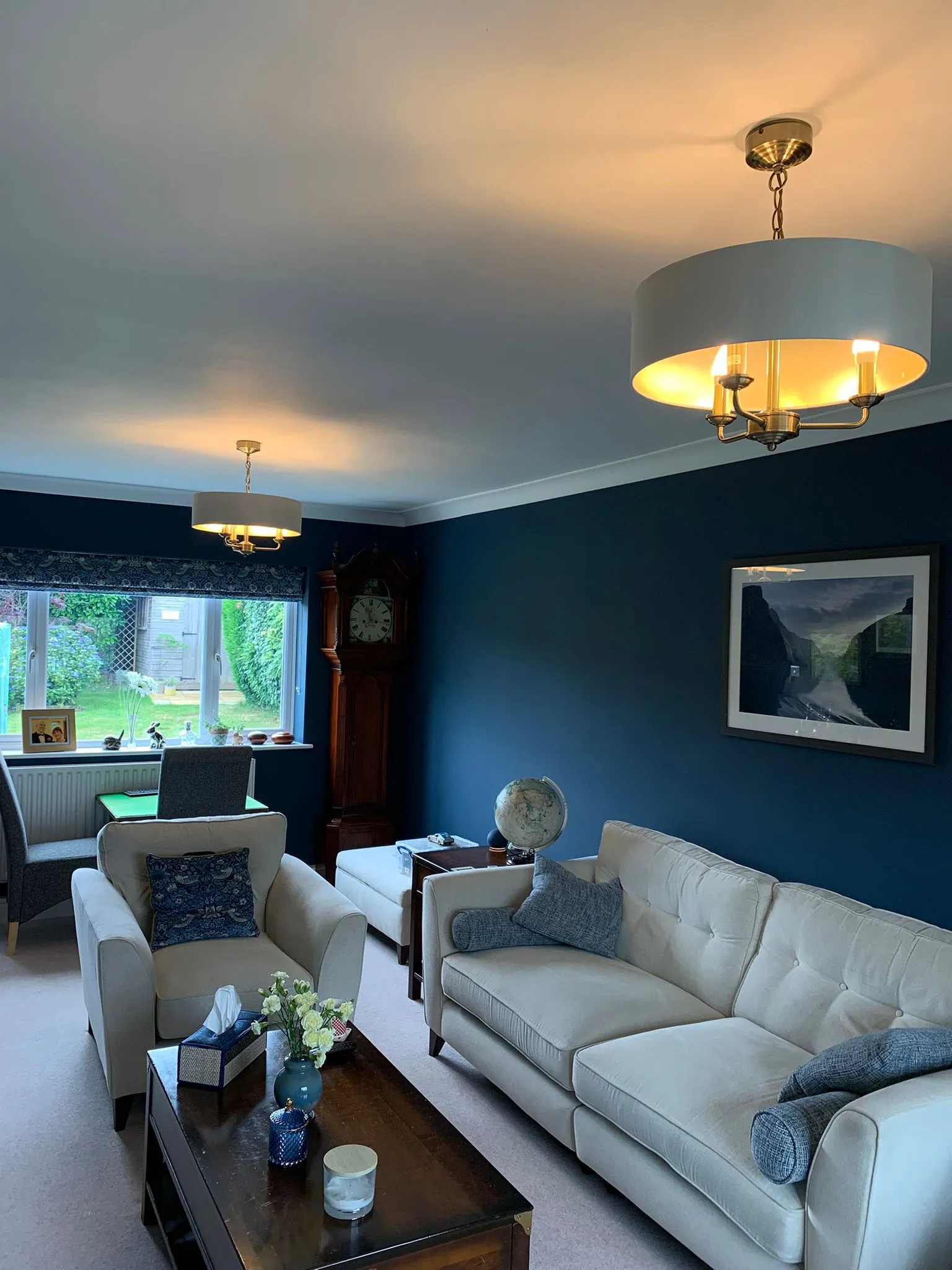 Pair of brass and drum shade pendant feature lights installed in a living room