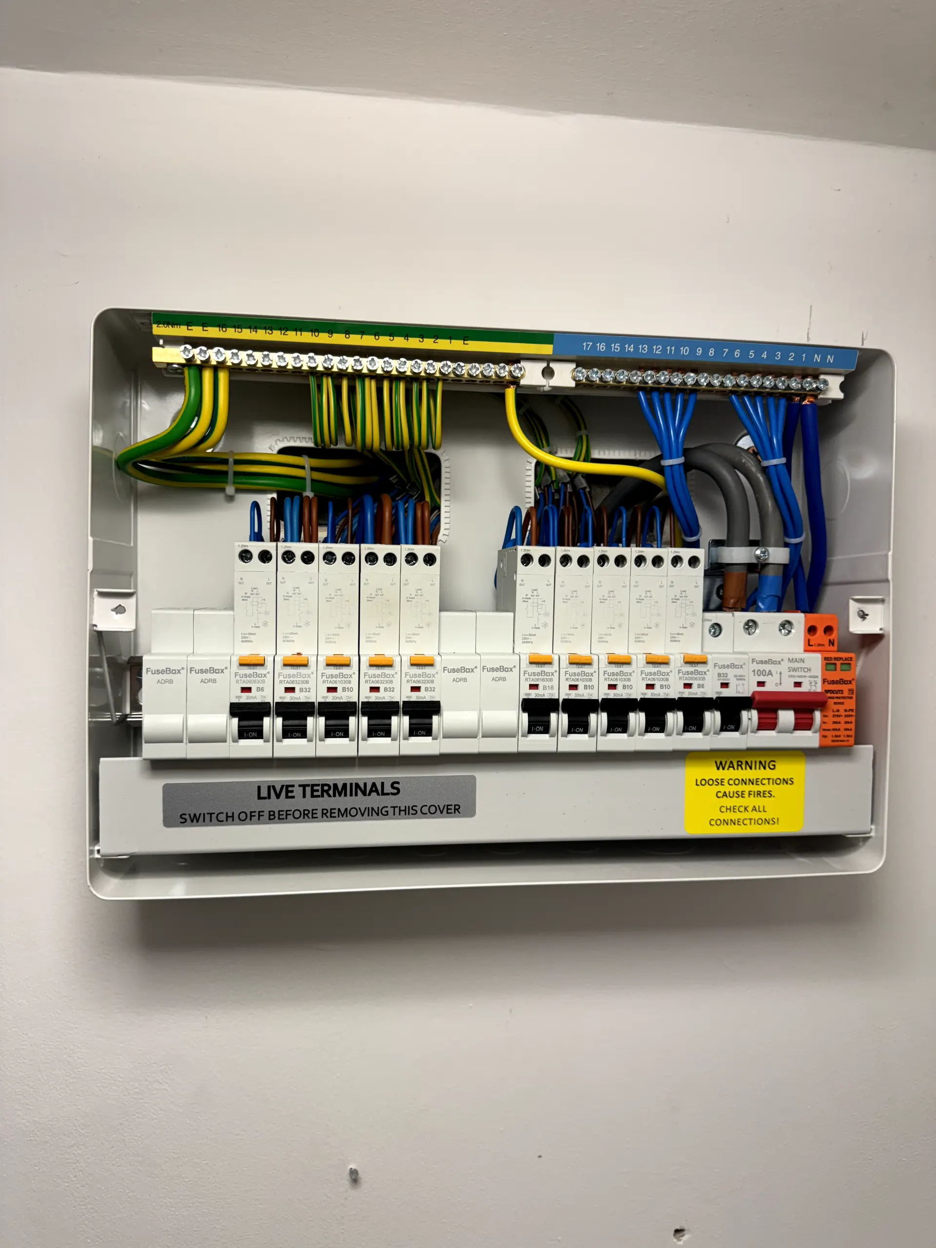 Internal wiring of a modern, 18th Edition compliant consumer unit featuring RCBOs and surge protection, installed by expert electricians in Warrington