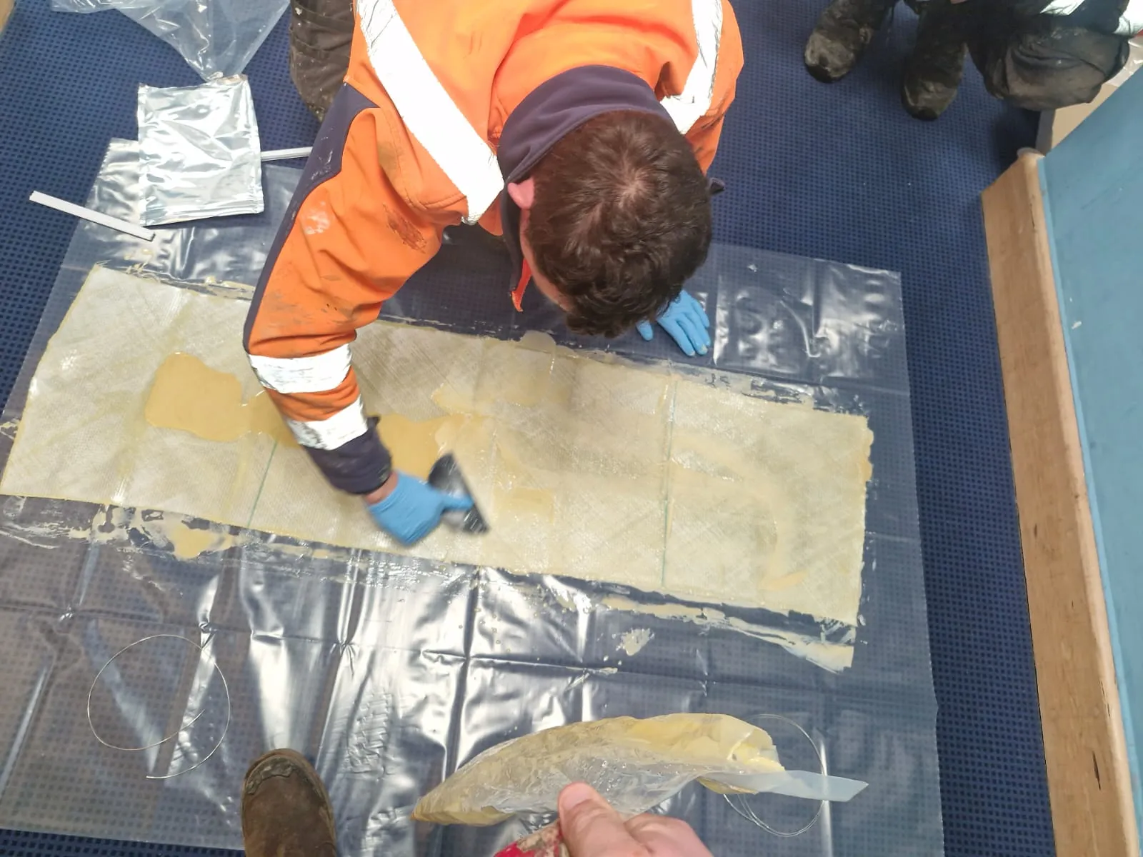 A drainage engineer preparing a resin patch for a no-dig trenchless drain repair