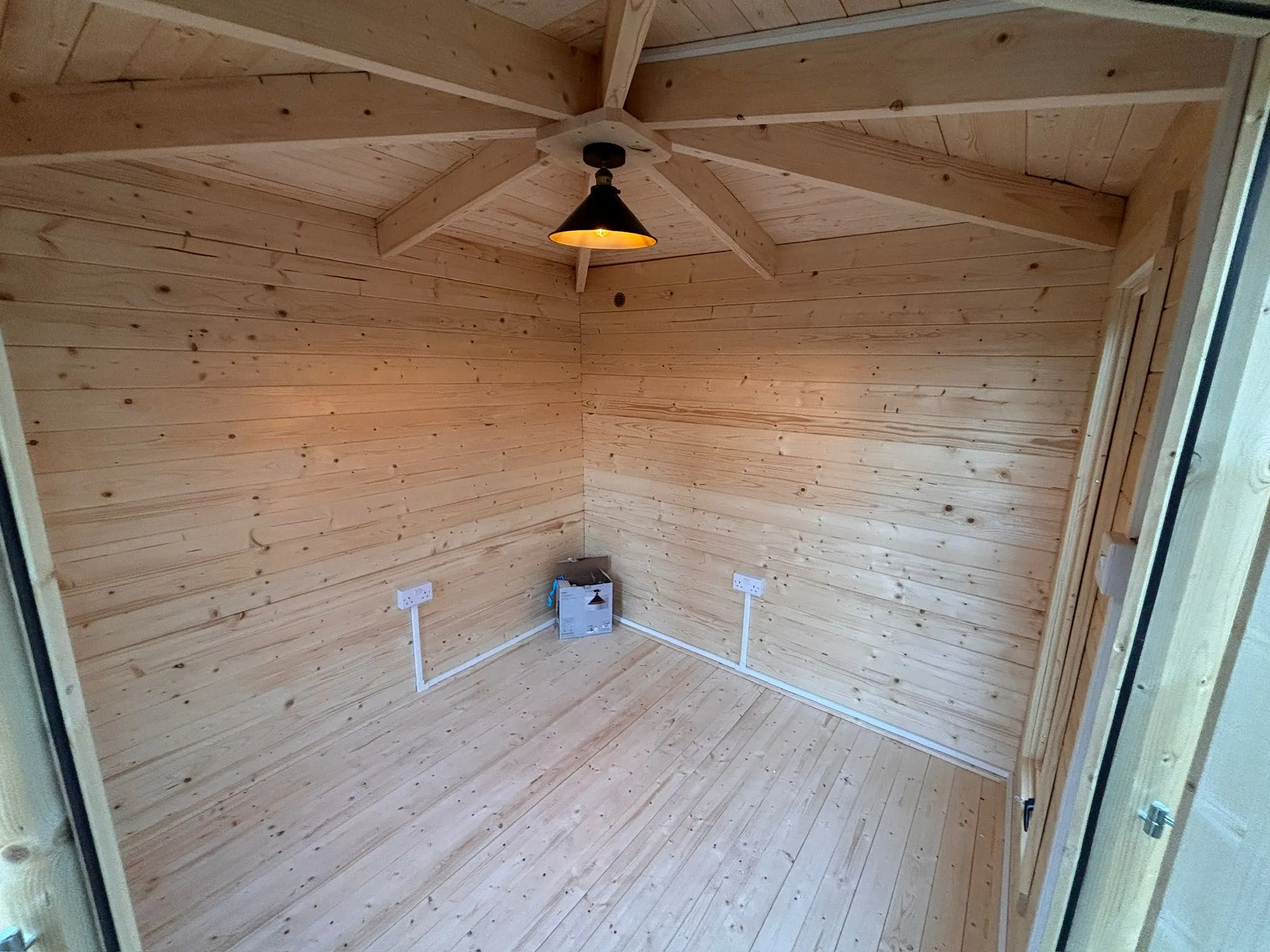 Garden office electrical installation in a timber outbuilding featuring pendant lighting and surface mounted sockets