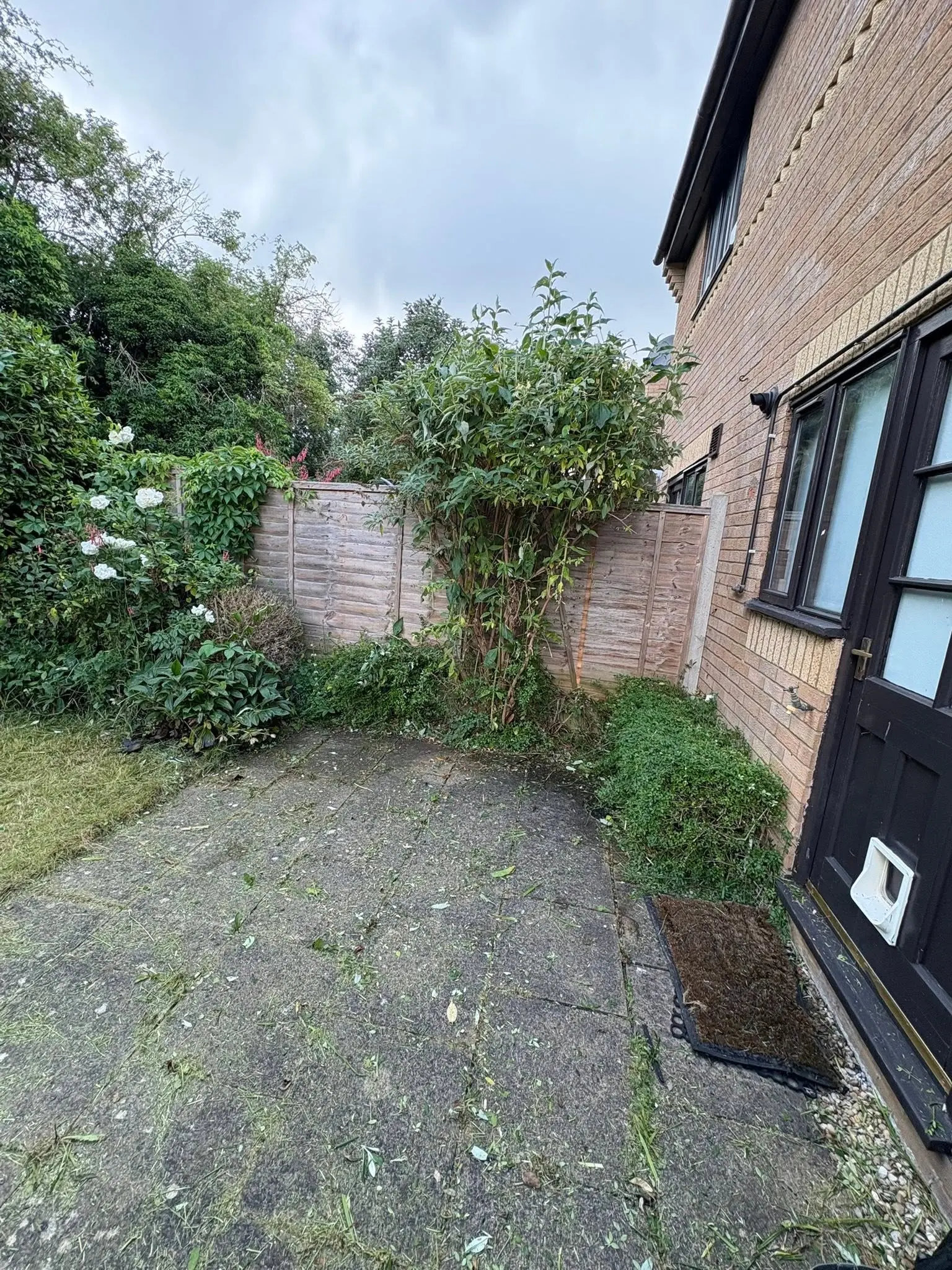 Green waste and clippings on a domestic garden patio after garden maintenance work