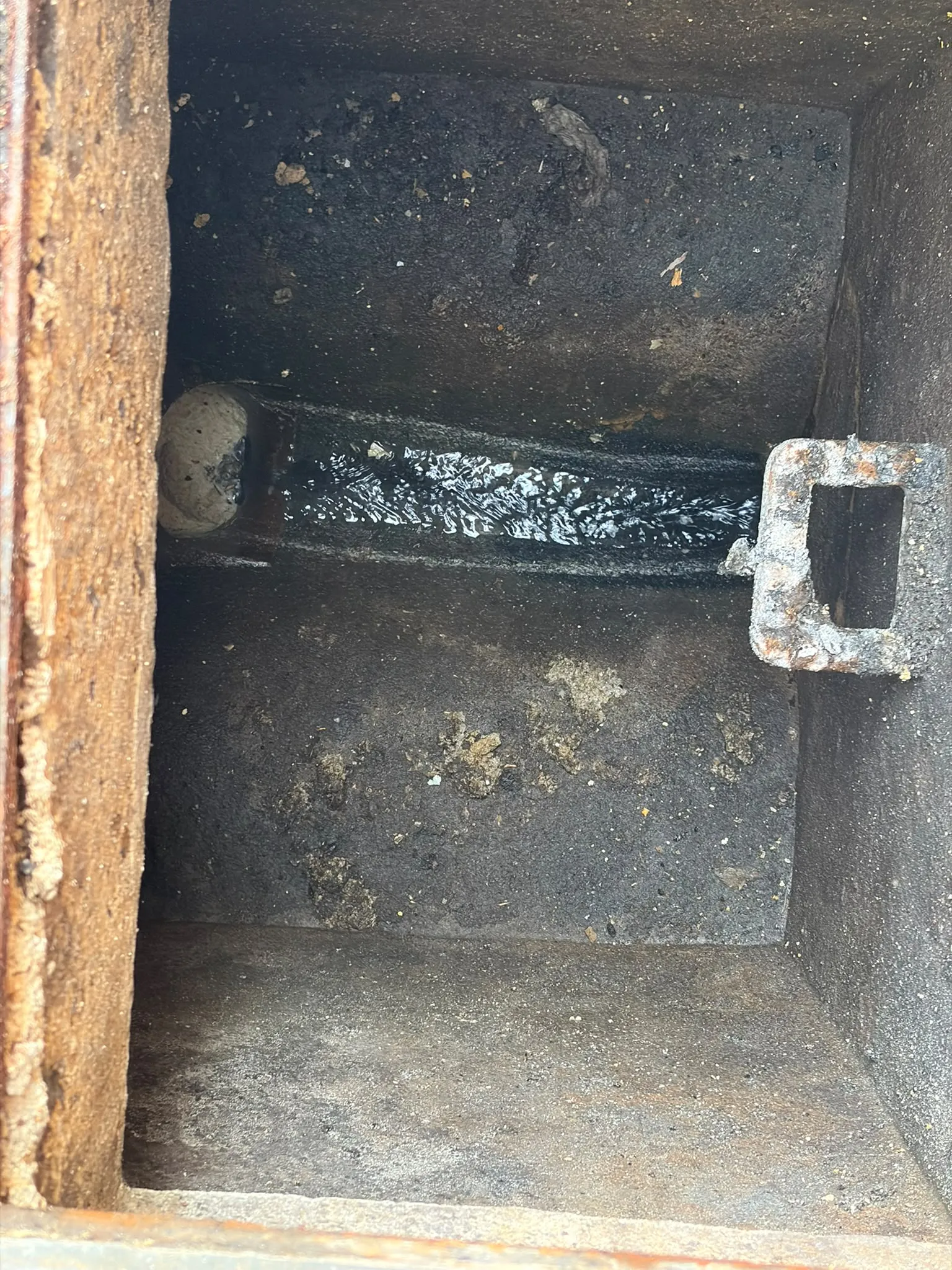 Drainage inspection chamber and manhole channel cleared and flowing in Slough