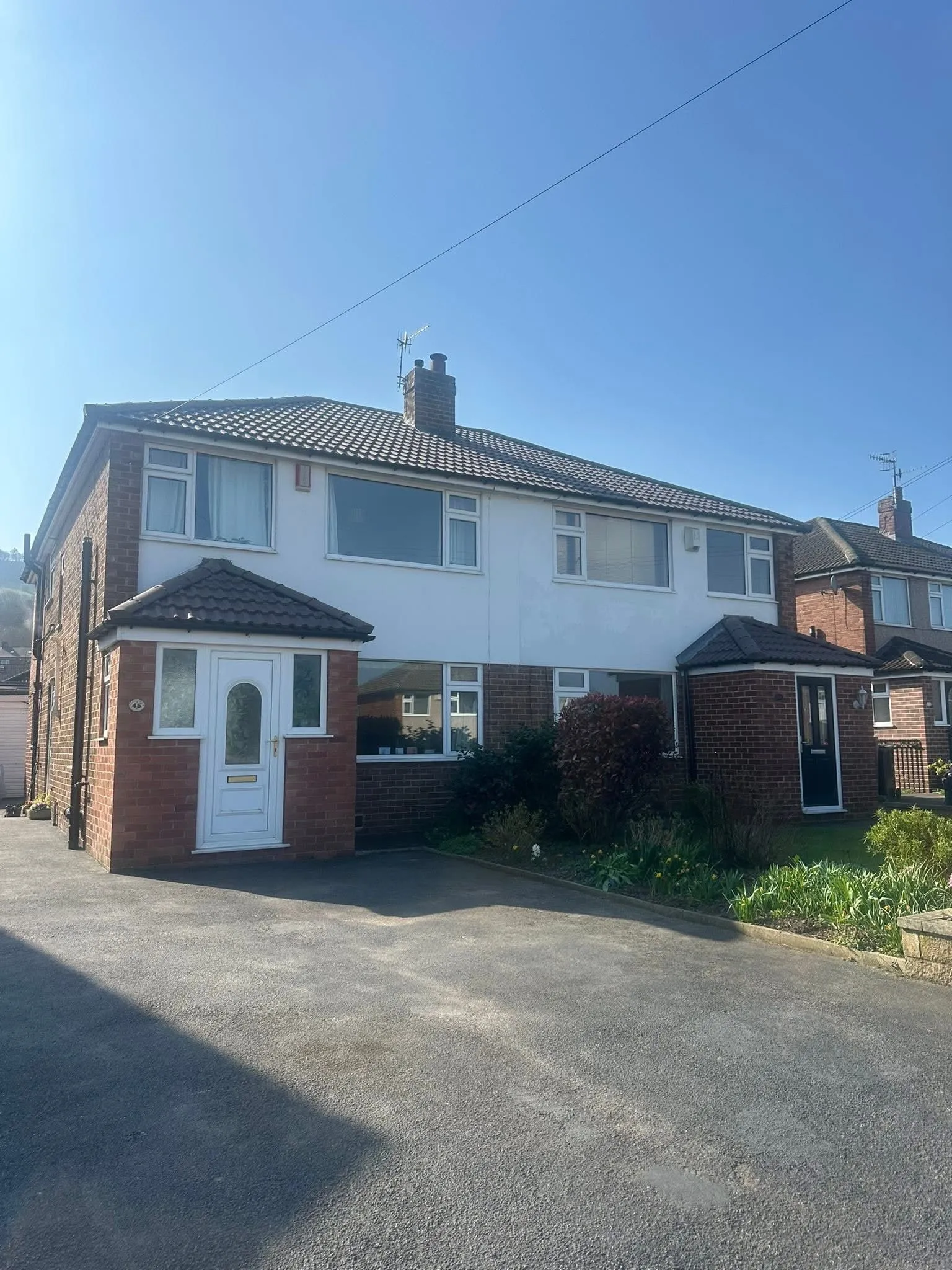 Semi-detached residential property with a tiled pitched roof, representative of roofing projects in Otley and Leeds.
