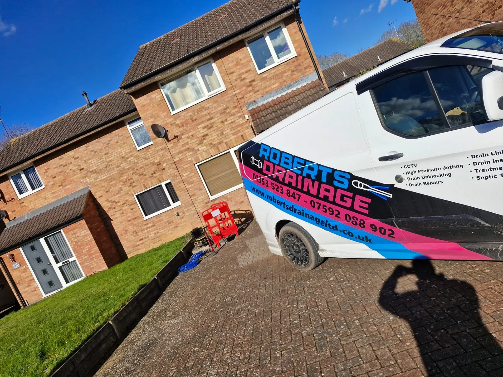 Roberts Drainage Ltd service van parked outside a residential house for drainage maintenance and repair services.