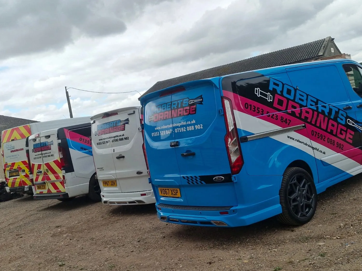 A fleet of Roberts Drainage Ltd service vans ready for emergency drain unblocking and repairs in Cambridgeshire.