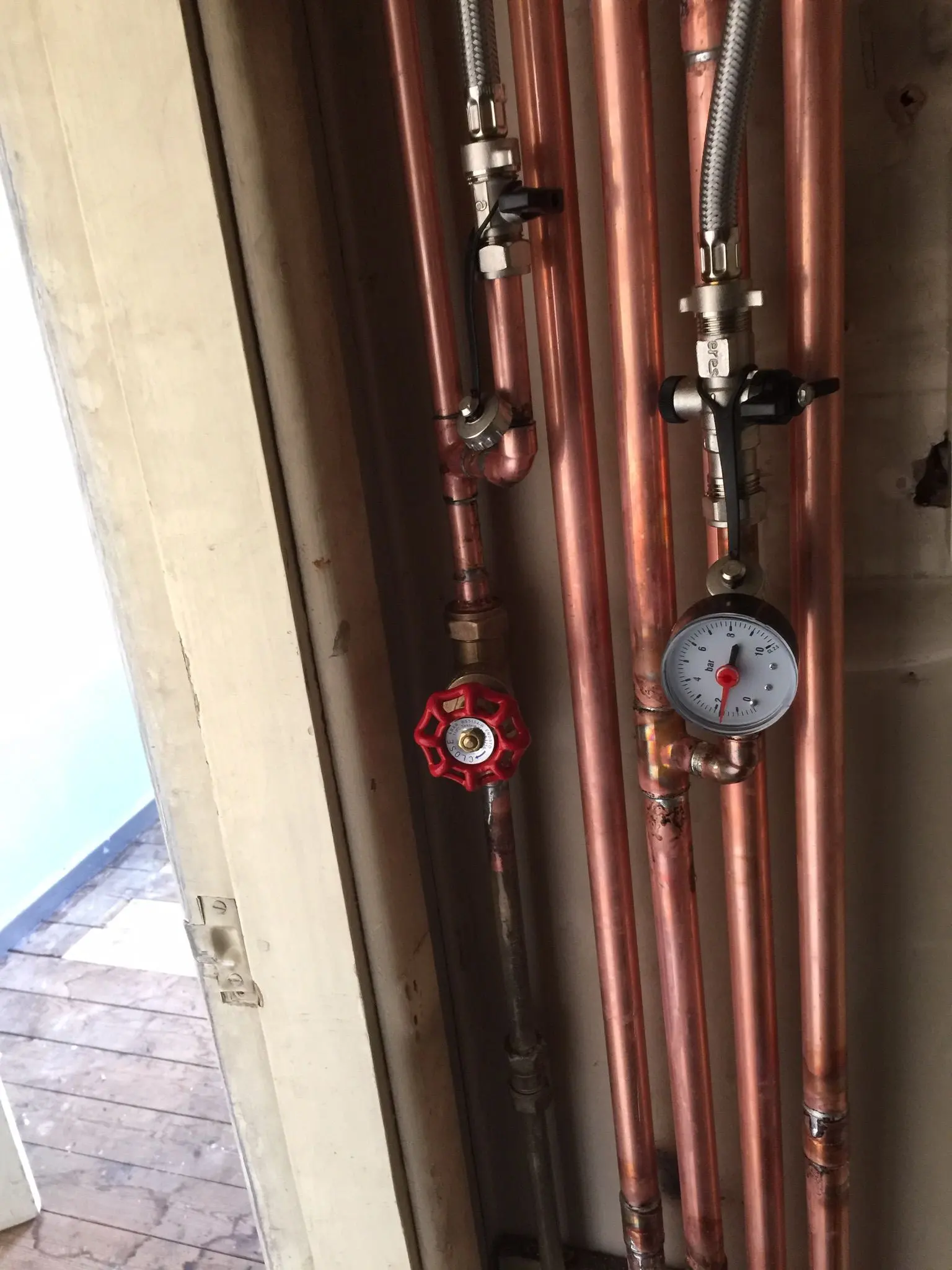 Professional copper plumbing installation with pressure gauge and valves by Fact Services in Wolverhampton