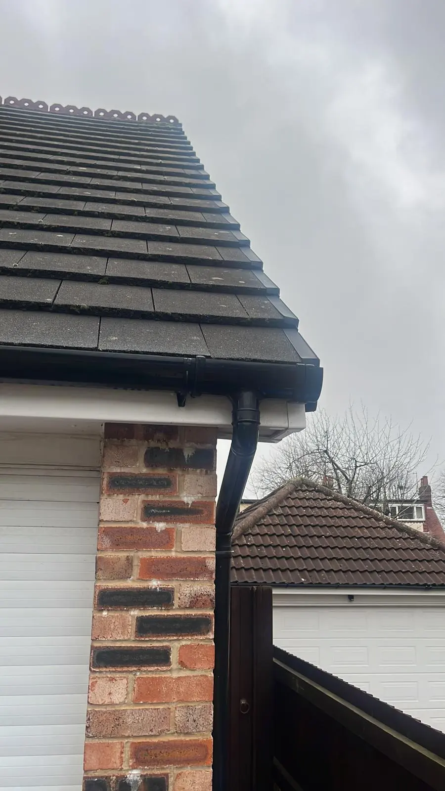 Professional uPVC fascias, soffits, and black guttering installation on a tiled roof