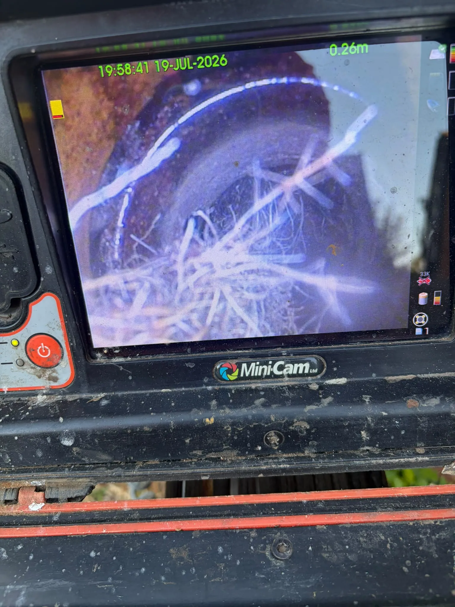 CCTV drain survey monitor showing tree root ingress blocking an underground pipe in Slough