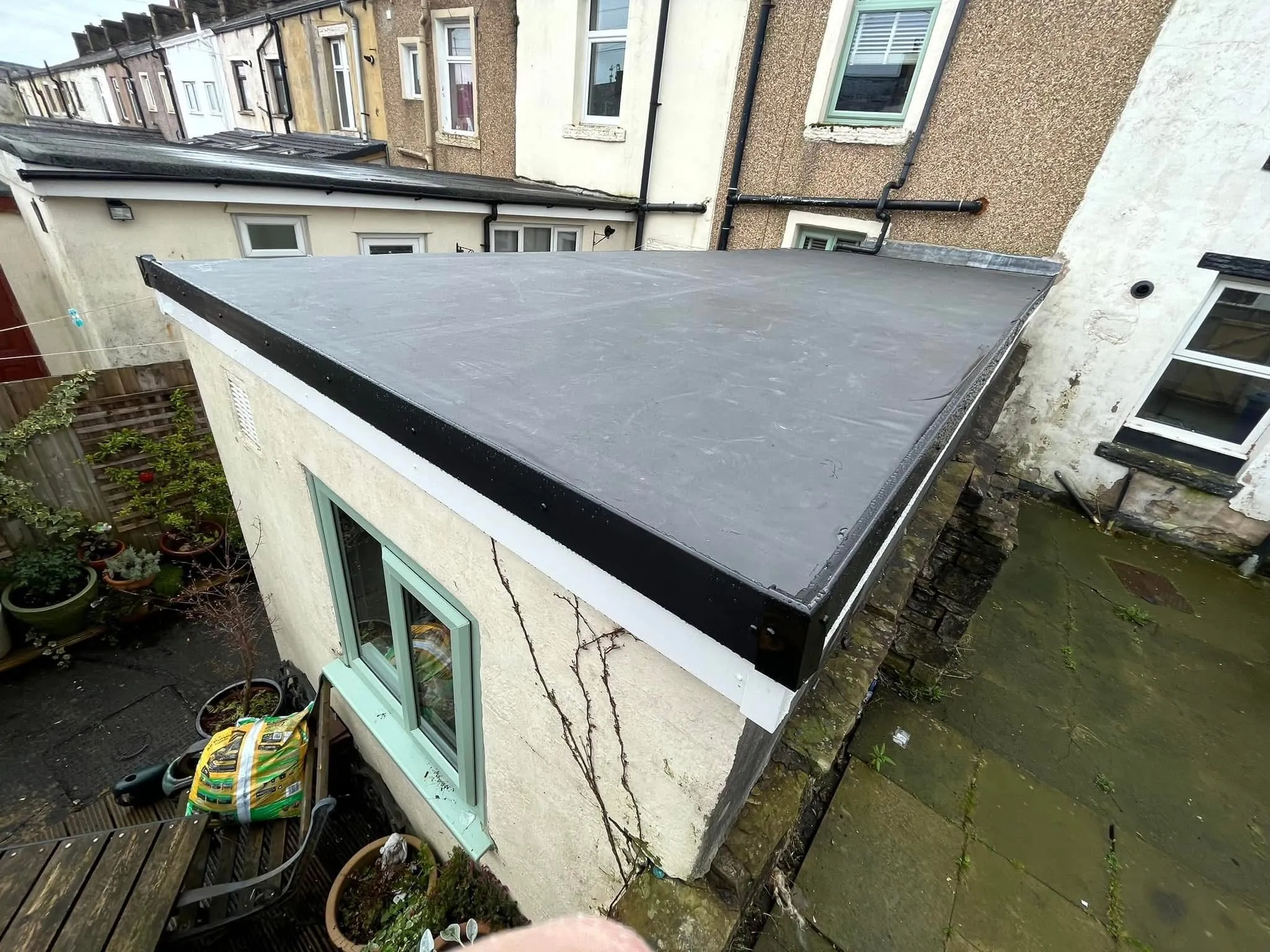 High-quality EPDM rubber flat roof installation by Lancashire Roofing Specialist in a residential backyard.