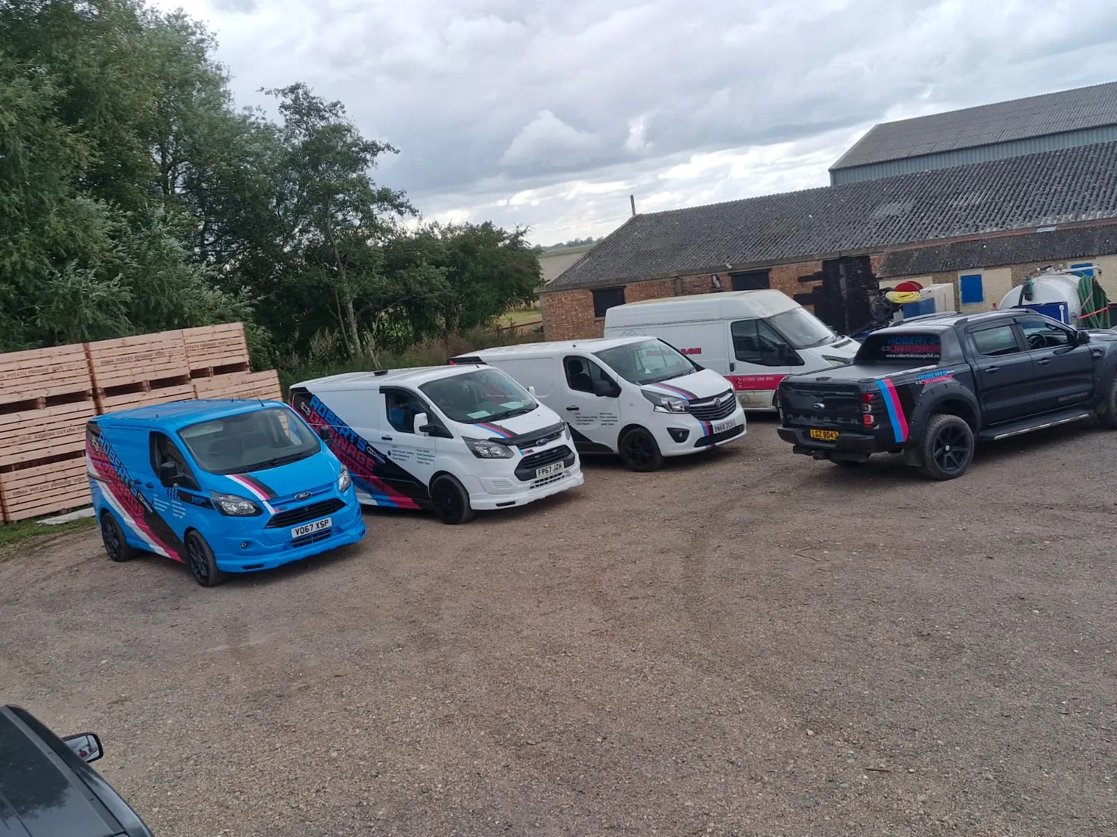 Roberts Drainage Ltd service vehicle fleet parked in a yard
