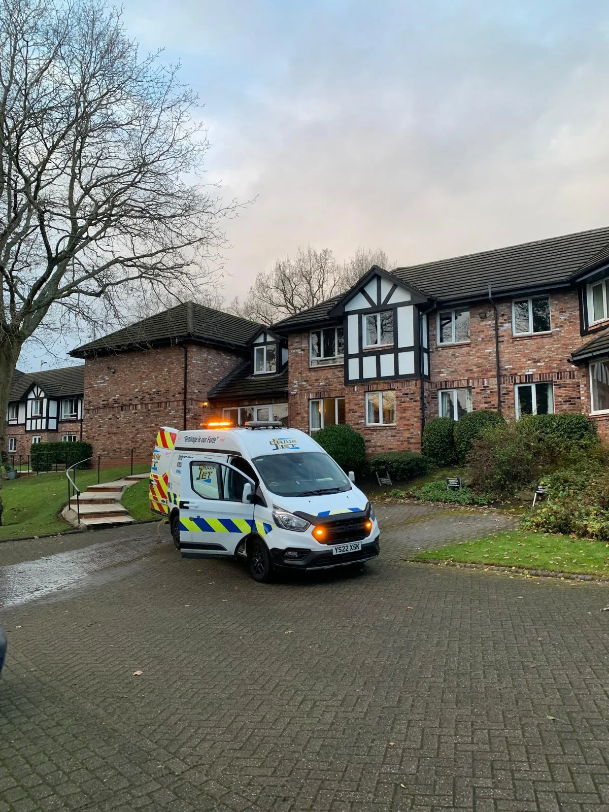 Professional Drain Jet van parked at a residential property in Leeds for drainage services.