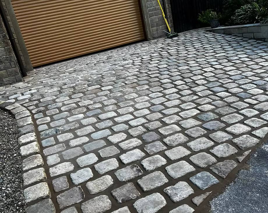 Cleaned block paved driveway after power washing
