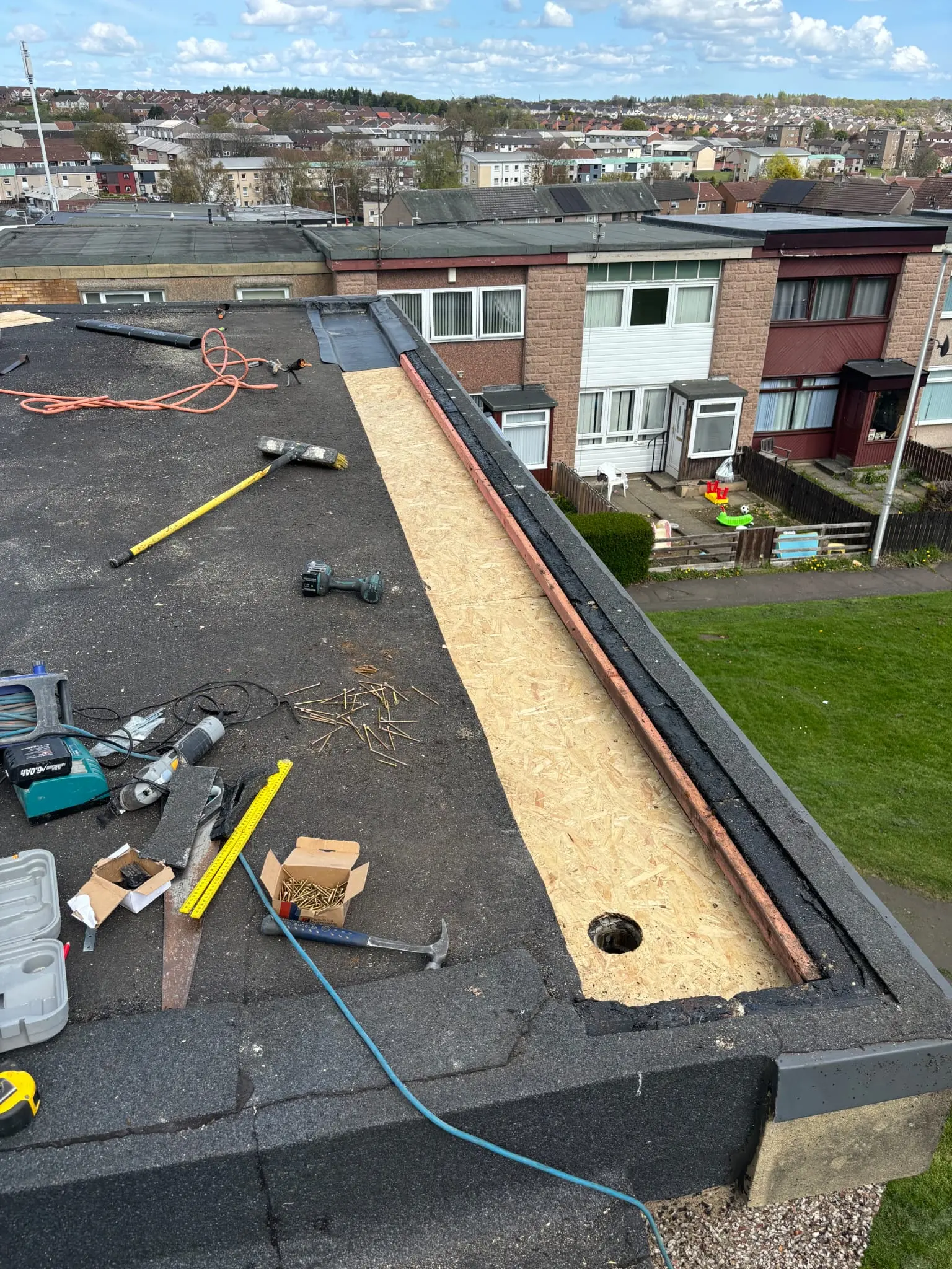 Flat roof repair in progress showing new timber decking being installed