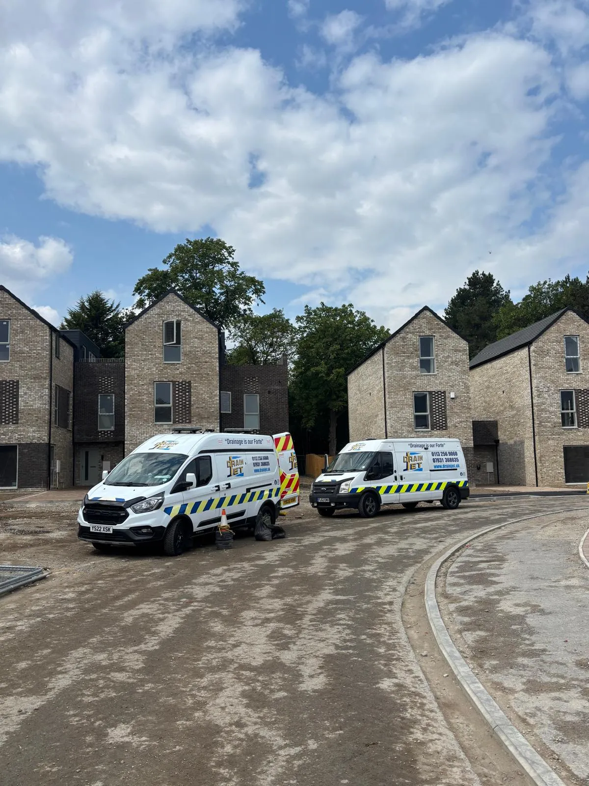 Drain Jet fleet vans on-site at a new housing development in Leeds